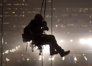 man hanging from ropes